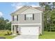 Attractive two-story home showcasing gray siding, white trim, and a two-car attached garage at 315 Limestone Circle, Conyers, GA 30013