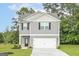 Charming two-story home features gray siding, black shutters, and an attached two-car garage at 315 Limestone Circle, Conyers, GA 30013