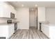 Contemporary kitchen featuring white cabinetry, stainless steel appliances, and a stylish countertop island at 315 Limestone Circle, Conyers, GA 30013