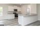 Well-lit kitchen boasts white cabinets, granite countertops, and stainless steel appliances at 315 Limestone Circle, Conyers, GA 30013