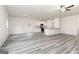 Open-concept living space features sleek floors, recessed lighting, and a view into the bright kitchen at 315 Limestone Circle, Conyers, GA 30013