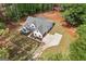 An aerial perspective of the house showing the roofline, expansive yard, long driveway, and natural surroundings at 4731 H D Atha Rd, Covington, GA 30014