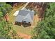 An aerial shot of the home and surrounding land, displaying roof architecture, long driveway, and lush, mature trees at 4731 H D Atha Rd, Covington, GA 30014
