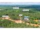 An aerial view showing a home nestled in a wooded lot, located near Lake Varner and Big Flat Creek in Covington, GA at 4731 H D Atha Rd, Covington, GA 30014