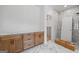 Bathroom featuring marble tile, custom wood cabinets, and a separate shower enclosure at 4731 H D Atha Rd, Covington, GA 30014