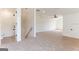 Spacious bonus room with plush carpeting, ceiling fan, and stairs to the next level at 4731 H D Atha Rd, Covington, GA 30014