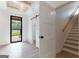 Bright entryway with wood ceiling, open doorway to yard, and staircase at 4731 H D Atha Rd, Covington, GA 30014