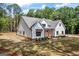 Charming home surrounded by well-kept lawn, highlighting architectural features like the roofline and design at 4731 H D Atha Rd, Covington, GA 30014
