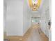 Bright hallway features decorative ceiling, light wood floors and doorways leading into other rooms at 4731 H D Atha Rd, Covington, GA 30014