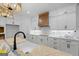 A bright, modern kitchen with white cabinets, a marble backsplash, and a wooden range hood at 4731 H D Atha Rd, Covington, GA 30014