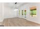 Bright living room featuring a modern chandelier, hardwood floors and double doors to the backyard at 4731 H D Atha Rd, Covington, GA 30014