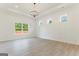Bright living room with hardwood floors, three windows and white walls, providing a comfortable space at 4731 H D Atha Rd, Covington, GA 30014