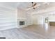 Spacious living area with a stone fireplace, built-in shelving, and hardwood flooring at 4731 H D Atha Rd, Covington, GA 30014