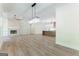 Open-concept living room with stone fireplace, built-in shelving, and hardwood flooring at 4731 H D Atha Rd, Covington, GA 30014