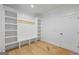 A mudroom features white built-in shelves and bench, plus light wood floors, offering an organized entryway at 4731 H D Atha Rd, Covington, GA 30014
