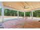 Spacious covered patio with an airy ceiling fan, and a clear view of the home's expansive property, perfect for outdoor relaxation at 4731 H D Atha Rd, Covington, GA 30014