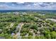 An aerial view showcases a residential area with lush trees and well-maintained homes at 4985 Rolling Rock Dr., Sugar Hill, GA 30518