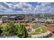 This aerial view showcases a vibrant commercial area with amphitheater surrounded by lush greenery at 4985 Rolling Rock Dr., Sugar Hill, GA 30518