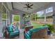 Relaxing back porch boasts a ceiling fan, TV, comfortable seating, and open access, ideal for leisure and entertainment at 4985 Rolling Rock Dr., Sugar Hill, GA 30518