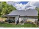 Spacious backyard featuring a covered patio, outdoor seating, a grill, and a kayak at 4985 Rolling Rock Dr., Sugar Hill, GA 30518