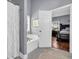 This bathroom has a tub, white shower curtain, and view into the main bedroom at 4985 Rolling Rock Dr., Sugar Hill, GA 30518
