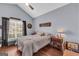 Well-lit bedroom with a ceiling fan, side tables, and decor creates a relaxing and inviting living space at 4985 Rolling Rock Dr., Sugar Hill, GA 30518