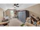 This bedroom features a ceiling fan, natural light, and neutral carpeting, offering a cozy space at 4985 Rolling Rock Dr., Sugar Hill, GA 30518