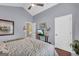 Comfortable bedroom featuring a ceiling fan, TV, and decor, creating a cozy and inviting living space at 4985 Rolling Rock Dr., Sugar Hill, GA 30518