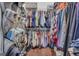 This large walk-in closet has many hanging clothes and shelves for shoes at 4985 Rolling Rock Dr., Sugar Hill, GA 30518