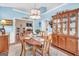 Elegant dining room with blue walls, white trim, and decorative furniture at 4985 Rolling Rock Dr., Sugar Hill, GA 30518