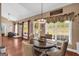 Bright dining room with large windows, hardwood floors, and a cozy seating area at 4985 Rolling Rock Dr., Sugar Hill, GA 30518