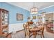 Dining room with blue walls, and wood floors with lots of natural light and wood furniture at 4985 Rolling Rock Dr., Sugar Hill, GA 30518