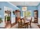 Dining room featuring blue walls, wood furniture, and plenty of natural light at 4985 Rolling Rock Dr., Sugar Hill, GA 30518