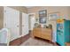 Stylish hallway offers two doors, wood dresser, and a vintage candy machine, blending practicality with unique charm at 4985 Rolling Rock Dr., Sugar Hill, GA 30518