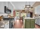 Modern kitchen with stainless steel appliances, a large island, and plenty of counter space with a breakfast area at 4985 Rolling Rock Dr., Sugar Hill, GA 30518