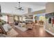 Open-concept living room with hardwood floors, high ceilings, and ample natural light at 4985 Rolling Rock Dr., Sugar Hill, GA 30518