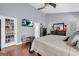 This main bedroom has a flat screen TV, dark wood bed set, and grey walls at 4985 Rolling Rock Dr., Sugar Hill, GA 30518
