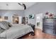 This main bedroom has a flat screen TV, dark wood bed set, and grey walls at 4985 Rolling Rock Dr., Sugar Hill, GA 30518