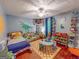 Bright bedroom with dinosaur theme features a play area and comfortable furnishings at 75 Grady Smith St, Grantville, GA 30220