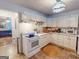 Bright kitchen features white cabinets, modern appliances, and an eat-in area with natural light at 75 Grady Smith St, Grantville, GA 30220