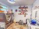 Well-stocked laundry room features a washer, dryer, storage, and organized shelving with home supplies at 75 Grady Smith St, Grantville, GA 30220