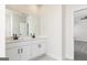 Modern bathroom featuring double sinks with dark fixtures and white cabinets at 481 Cantrell Drive, Dallas, GA 30157