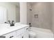 Modern bathroom features a white vanity with matte black hardware and a shower-tub combo with tiled walls at 481 Cantrell Drive, Dallas, GA 30157
