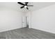Bright bedroom with gray flooring, a fresh coat of white paint, and a ceiling fan at 481 Cantrell Drive, Dallas, GA 30157