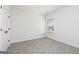 Bright bedroom with tan carpet, a window, a door, and a fresh coat of white paint at 481 Cantrell Drive, Dallas, GA 30157