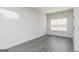 Well-lit bedroom with gray flooring, a fresh coat of white paint and two windows at 481 Cantrell Drive, Dallas, GA 30157
