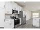 Modern kitchen with white cabinets, subway tile backsplash, and stainless steel appliances at 481 Cantrell Drive, Dallas, GA 30157