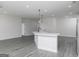 Spacious, open-concept kitchen with a white island, stylish pendant lights, and modern appliances at 481 Cantrell Drive, Dallas, GA 30157