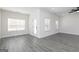 Well-lit living room with gray flooring and lots of natural light coming in through two windows at 481 Cantrell Drive, Dallas, GA 30157