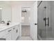 Bright bathroom featuring double vanity, framed mirror and stand-up shower with glass door at 539 Cantrell Drive, Dallas, GA 30157